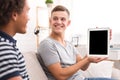 Happy guy showing digital tablet with blank screen Royalty Free Stock Photo