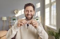 Portrait of happy, joyful, excited man holding key to his new house or apartment Royalty Free Stock Photo