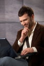 Happy guy smiling with laptop Royalty Free Stock Photo