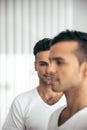 Happy guy standing near his brother at home