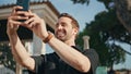 Happy guy talking phone camera on city street close up. Cheerful man video call Royalty Free Stock Photo