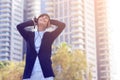 Good looking young man smiling and listening music on the street. Young man listening to music on a smart phone. Royalty Free Stock Photo