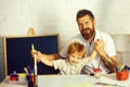 Happy guys. Family. Father and son draw together. Fun lessons, education at home. Progressive bearded teacher and happy