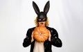 Happy Halloween. Beautiful woman in Halloween costume and bunny rabbit mask with pumpkin. Pretty female model in black Royalty Free Stock Photo