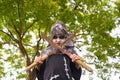 Happy halloween. Boy dressed up for halloween party holding a pair of rusty pruning shears. He is very angry looking at the camera