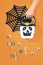 Happy halloween with candies and bucket on orange background