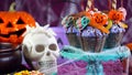 Halloween candyland drip cake style cupcakes in party table setting. Royalty Free Stock Photo