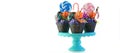 Halloween candyland drip cake style cupcakes with lollipops and candy on white.