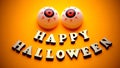 HAPPY HALLOWEEN. Template for design for the holiday of all saints. A cheerful face with emotion from wooden letters and two balls Royalty Free Stock Photo