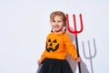 Happy Halloween. A child in a devil costume with a Trident