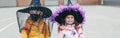 Happy Halloween. Children girls friends in witch costumes and face protective masks. People school students celebrating Halloween