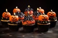 Happy Halloween with chocolate cupcakes decorated with evil pumpkins
