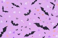 Halloween backdrop made of different bats on a purple background.