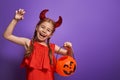 Little devil with a pumpkin Royalty Free Stock Photo