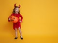 Little devil with a pumpkin Royalty Free Stock Photo