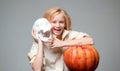 Happy Halloween Cute little girl making funny faces with a pumpkin. Cute little witch with a pumpkin. Royalty Free Stock Photo