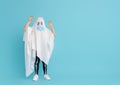 Kid in ghost costume wearing face mask Royalty Free Stock Photo