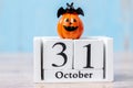 Happy Halloween day with 31 October calendar wood, jack o lantern pumpkin and bat decor with funny face on table background with Royalty Free Stock Photo