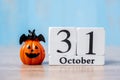 Happy Halloween day with 31 October calendar wood, jack o lantern pumpkin and bat decor with funny face on table background with Royalty Free Stock Photo