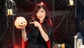 Happy halloween day. Portrait Asian beautiful woman model dressed as a witch costume smile and holding pumkin in halloween theme Royalty Free Stock Photo