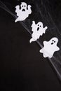 Halloween Decoration and horror concept - spider web with ghosts over black background Royalty Free Stock Photo