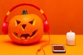 Happy Halloween decorations festival and music concept background.Mix variety candle items and pumpkin listening music Royalty Free Stock Photo