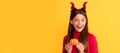 happy halloween. devil kid with pumpkin. trick or treat. teen girl on yellow background. Halloween kid girl portrait Royalty Free Stock Photo