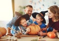 Happy Halloween! family mother father and children cut pumpkin for holiday at home Royalty Free Stock Photo