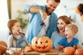 Happy Halloween! family mother father and children cut pumpkin for holiday at home Royalty Free Stock Photo
