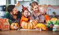 Happy Halloween! family mother father and children cut pumpkin f Royalty Free Stock Photo