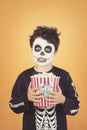 Happy Halloween.funny child in a skeleton costume with popcorn