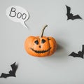 Happy halloween. Funny halloween pumpkin with speech bubble and paper bats on gray background
