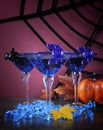 Happy Halloween ghoulish party cocktail drinks with blue martini glasses Royalty Free Stock Photo