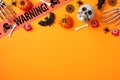 Happy Halloween greeting card design. Frame border made of skull, pumpkins, bats, bloody eyes, bones, skeleton hands, warning tape