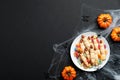 Happy halloween holiday concept. Cookies in form of witches fingers, pumpkins, spiderweb, spiders on black background. Halloween