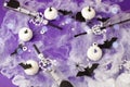 Happy Halloween holiday concept. Scary decorations, spider web, pumpkins, bats, bottles for cocktails and straws on purple Royalty Free Stock Photo