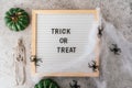 Happy halloween holiday concept. Skeletons, spider, web, pumpkin, trick or treat text on board frame on concrete grey Royalty Free Stock Photo