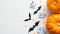 Happy Halloween holiday flat lay composition with cute decorations. Top view pumpkins, ghosts, bats on white background Royalty Free Stock Photo