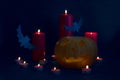 Happy Halloween holiday party Composition with Jack O` Lantern pumpkins, party decorations, bats and candles on blue background. Royalty Free Stock Photo