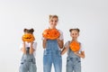 Happy halloween and holidays concept - A mother and her daughters with pumpkins. Happy family preparing for Halloween.