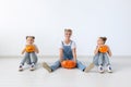 Happy halloween and holidays concept - A mother and her daughters with pumpkins. Happy family preparing for Halloween.