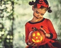 Happy Halloween! horrible creepy child girl in pumpkin costume