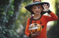 Happy Halloween! horrible creepy child girl in pumpkin costume