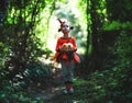 Happy Halloween! horrible creepy child girl in pumpkin costume