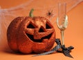 Happy Halloween Jack-o-lantern pumpkin with skeleton hand glass