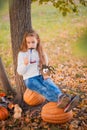 Happy Halloween! Little girl carving pumpkin at Halloween. Dressed up children trick or treating. Kids trick or treat. Toddler kid