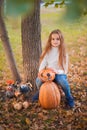 Happy Halloween! Little girl carving pumpkin at Halloween. Dressed up children trick or treating. Kids trick or treat. Toddler kid