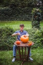 Happy halloween. Man carving big pumpkin Jack O Lanterns for Halloween outside. Close-up Royalty Free Stock Photo