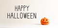 Happy Halloween message with a small pumpkin
