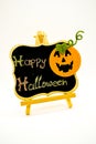 Happy Halloween message write on a blackboard with pumpkin. Isolated on white background.